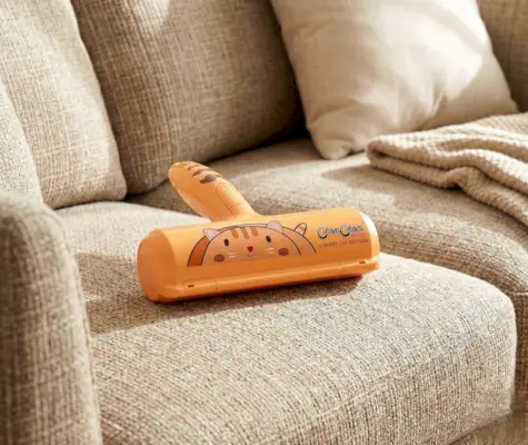 ChomChom pet hair remover roller with a bright orange handle and dog pattern.
